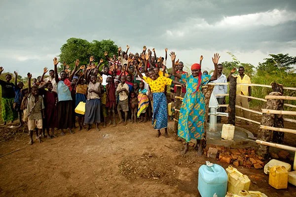 Villagers celebrating at a new water pump